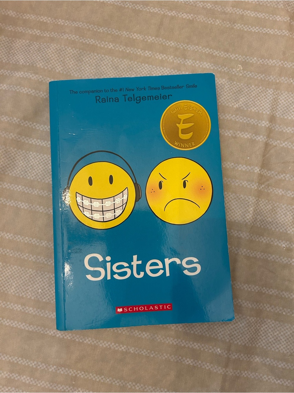 Scholastic Blue Cover Graphic Novel with Yellow Emoji Faces